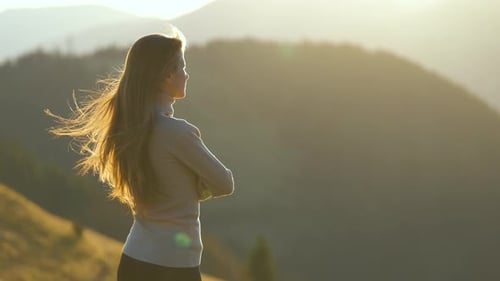 Hiker Woman Standing on Mountain Footpath Enjoying Evening Nature During Her Travel on Wilderness