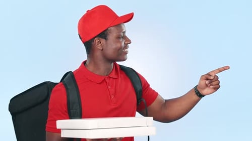 Pizza delivery man, box and smile in studio, pointing and list for menu