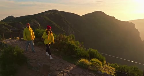 Couple Hiking at Sunrise in the Mountains