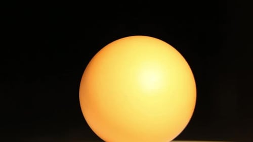 Yellow Egg Rotating on a Black Background