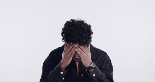 Man, stress and depression or anxiety in studio with hands on face while frustrated and angry