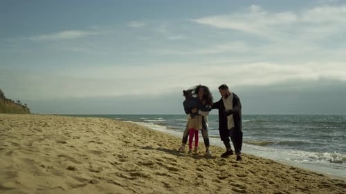 Lovely Family Hugging Together by Beach Sea. Young Joyful Mom Dad Kid