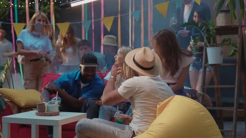 Young Adults Enjoying a Birthday Party Celebration at Night