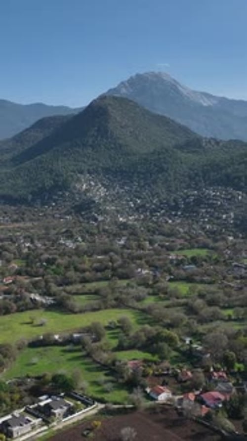 Panoramic view of a village nestled in a valley with a majestic