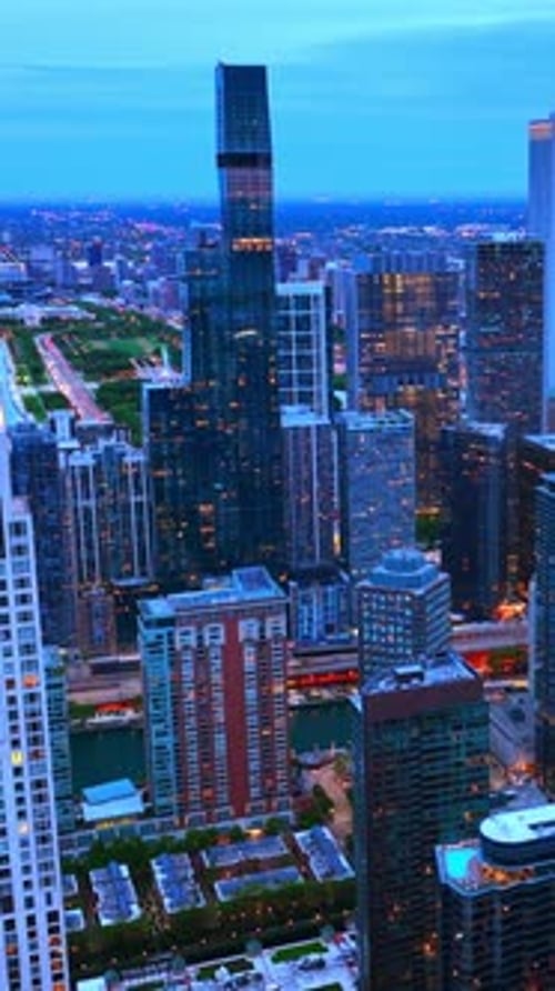Chicago scenic view in the twilight. Grand skyscrapers full of lights.