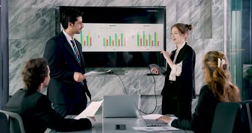 Business team discussing bar chart presentation while standing executives reviewing report content