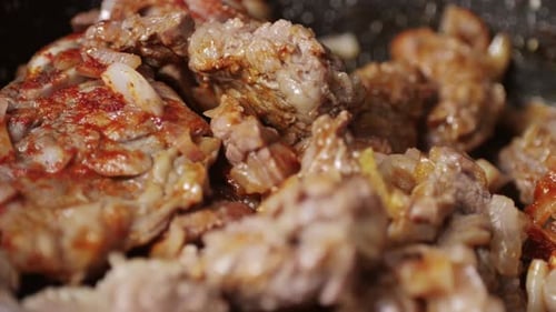 Chicken or Pork Stew with Red and Green Pepper Onion and Spices Cooking in a Frying Pan Traditional