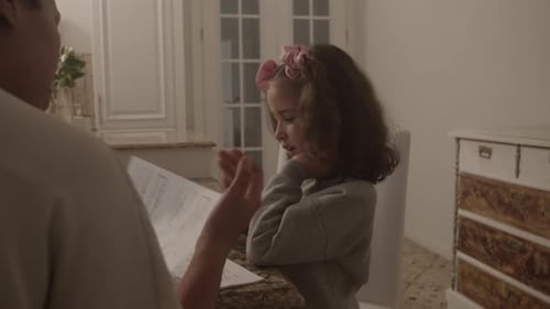 Child Learning Braille with Adult in Kitchen