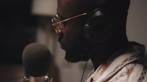 Man Speaking into Microphone in Studio