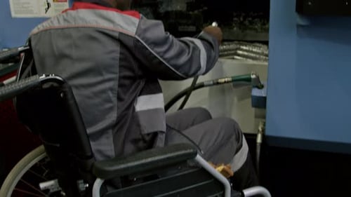 Workman with Disability Using Air Blow Gun at Factory
