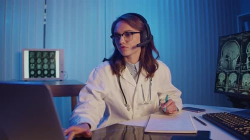 Female Doctor Telemedicine Consultation Analyzing Brain Scans