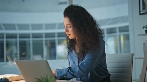Legal Manager Working Documents in Evening Office Smiling Late Businesswoman