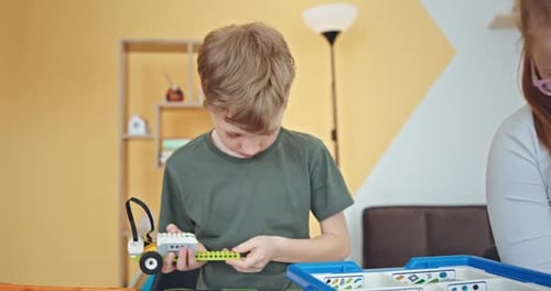 School Kids Boys Helping in Building Robotic Car Learning Together at STEM Class Happy Students