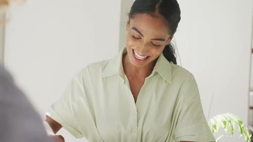 Happy diverse couple drinking coffee and talking at a table in a cafe