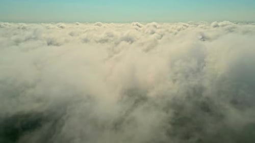 Drone aerial pan landscape of cloud coverage overcast misty haze fog smoke in sky peaceful horizon s