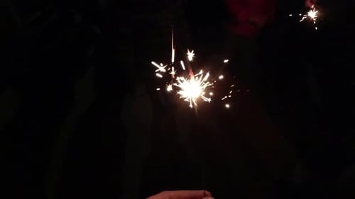 Sparkling Sparklers Burning in the Dark Night
