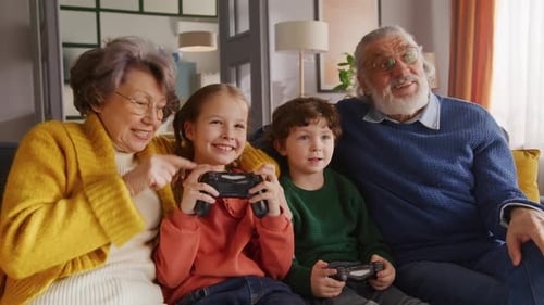 Grandparents and Grandchildren Play Video Games Together at Home