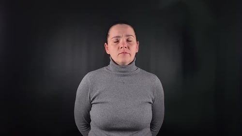 Woman Acting Out Emotions Against Dark Background