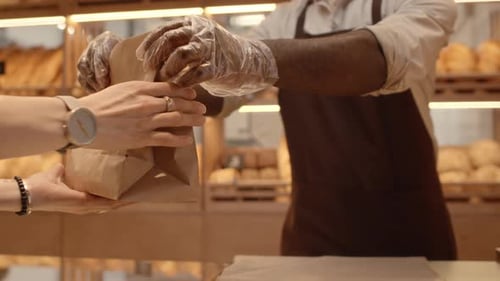 Bakery Salesman Giving Takeout Order to Customer