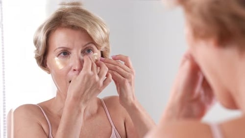 Woman Applies Eye Patches for Skincare Routine