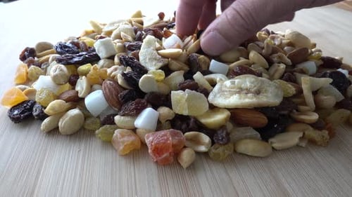 Eating Dry Nuts on Wooden Table