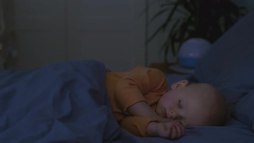 Baby Sleeping Soundly in Bed at Night