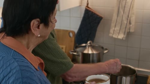 Senior Couple Cooking in Kitchen Together