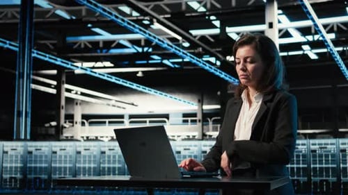 Data Center Software Developer Optimizing Server Load Balancing Using Laptop