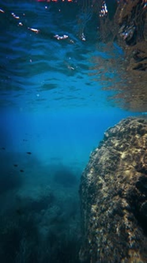 The View Between Water Surface And Rocks