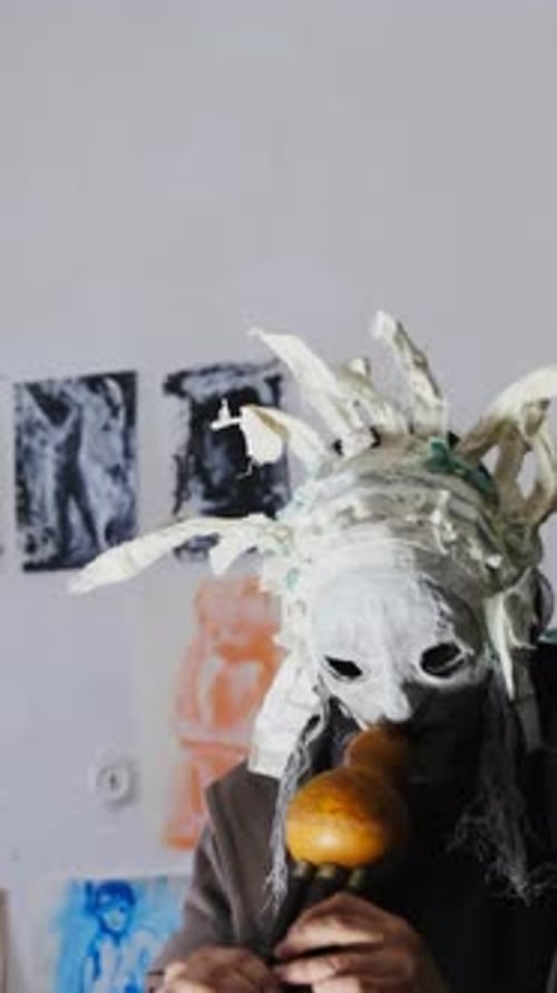 Guy Uses Face Covering to Attract Attention in Studio