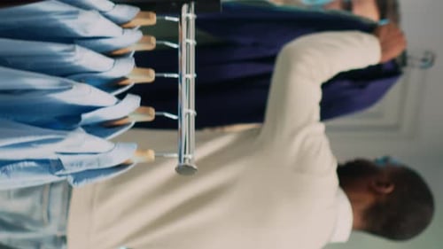 Vertical Video African American Man Paying for New Modern Clothes