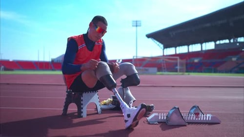 Disabled athletes prepare in starting position ready to run on stadium track