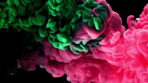 Swirling Green and Pink Ink on Black Background
