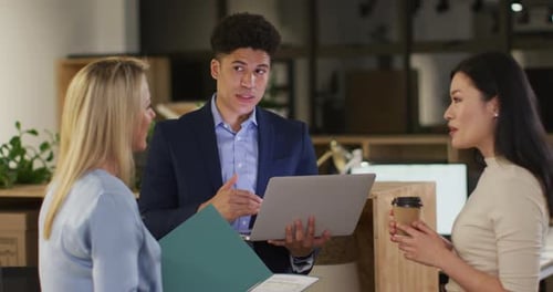 Caucasian woman and biracial man in a business meeting at the office