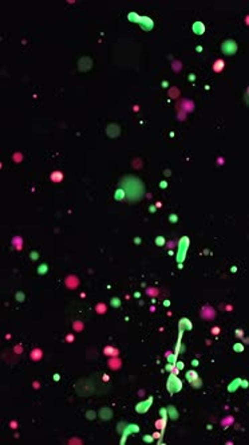 Vibrant Neon Pink And Green Paint Splashes In Slow Motion