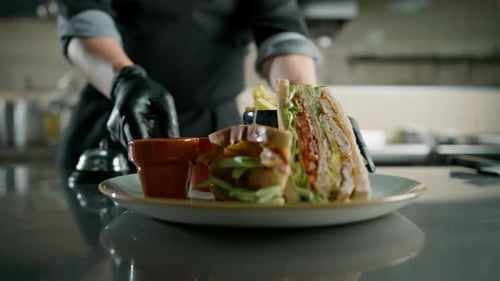 Professional kitchen in the hotel restaurant, the chef presses the bell the club sandwich is ready
