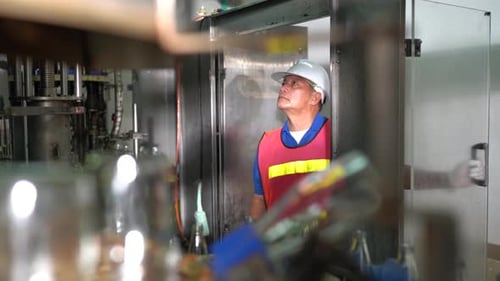 Factory Workers checking Machinery