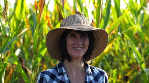 Happy Smiling Female Farmer Looks Into Camera Standing Near Corn Field Portrait of Adult Beautiful