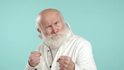 Senior Man with Beard Makes Fists