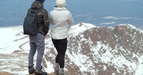 Couple on Top of Rocky Mountains, Close Up View From Peak Adventure