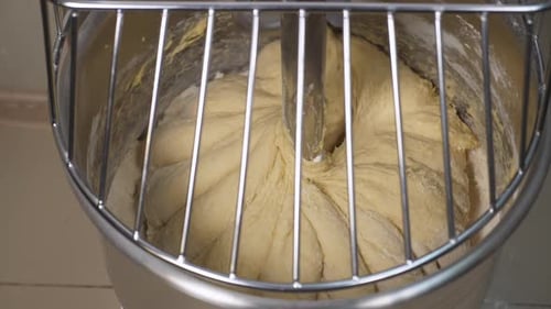 Closeup of the Bun Dough Being Kneaded in a Large Food Processor Burger Buns