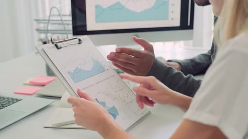 Businesspeople Reviewing Data in Modern Workplace