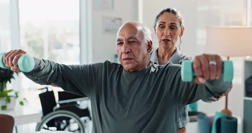 Senior Man Exercises with Assisted Living Healthcare Worker