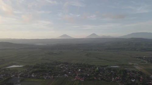 Aerial mountain in Indonesia near village with sunrise background