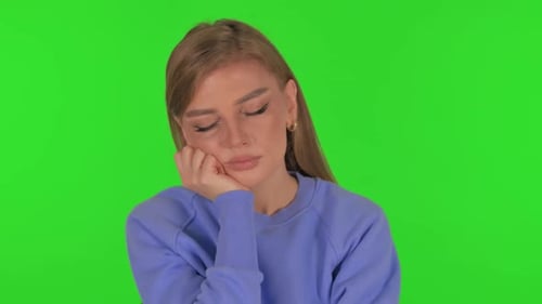 Tired Woman Sleeping on Green Background