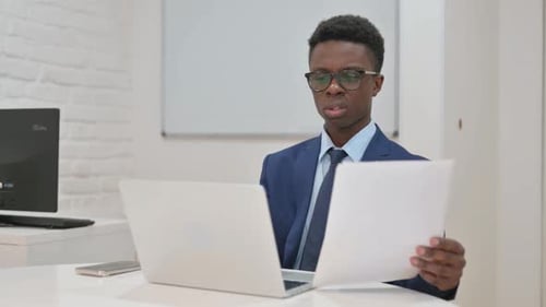 Businessman Reviews Documents and Celebrates Good News