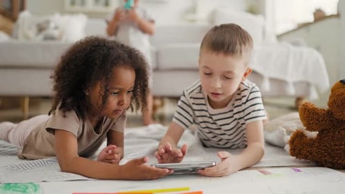 Children Using Phone Together at Home