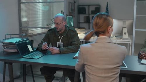 People in Camouflage Discussing Matters in Office