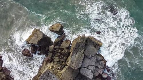Aerial view Drone camera of seashore rocks. Amazing sea waves crashing on rocks seascape.