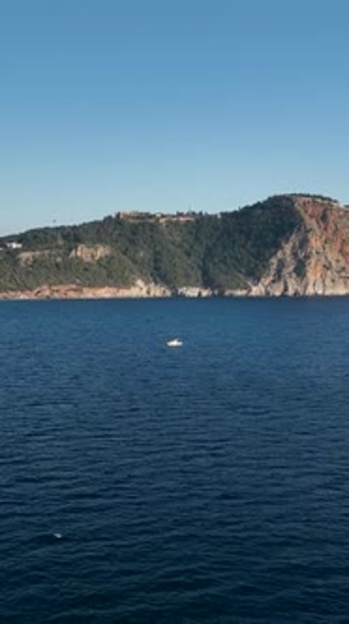 Vertical Video Fishing Boat's Coastal Journey Aerial View of the Mediterranean Sea